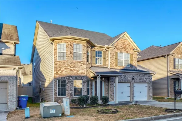 a front view of a house with garden