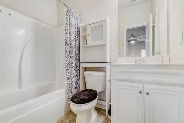 a bathroom with a toilet a sink and bathtub