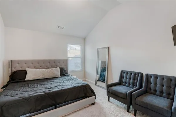 a bedroom with a bed and a couch