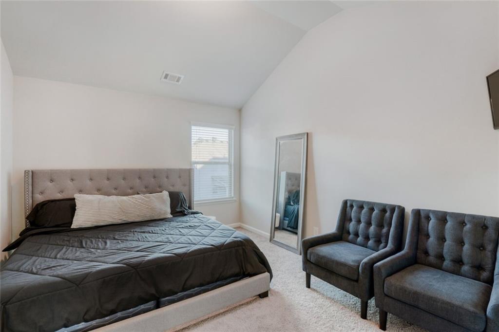 7607 Crawford Court Fairburn, GA 30213 - Photo 23 of 32 a bedroom with a bed and a couch