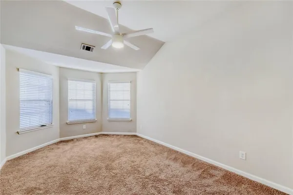 an empty room with a empty space and windows