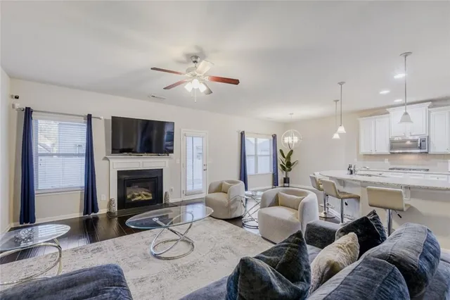 a living room with furniture a fireplace and a flat screen tv