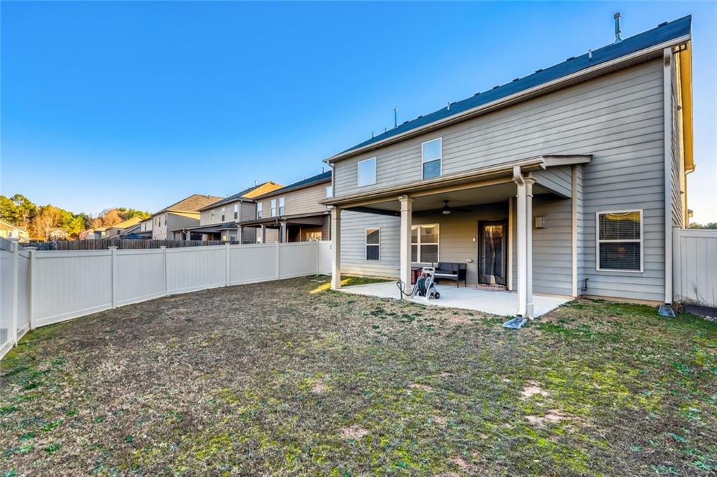 7607 Crawford Court Fairburn, GA 30213 - Photo 32 of 32 a view of a house with wooden floor and a yard