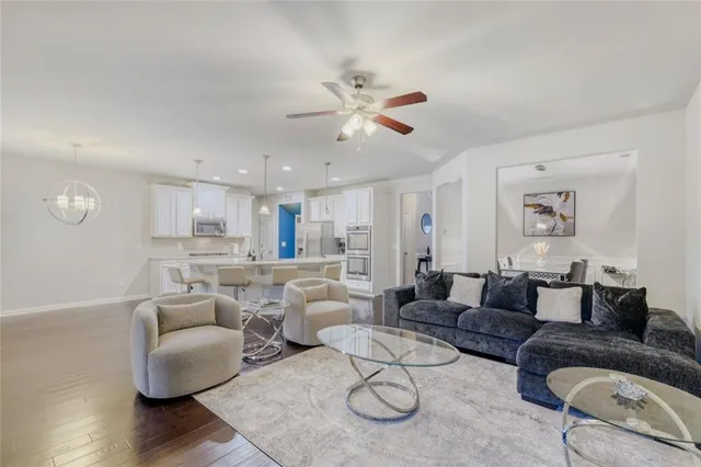 a living room with furniture and a wooden floor