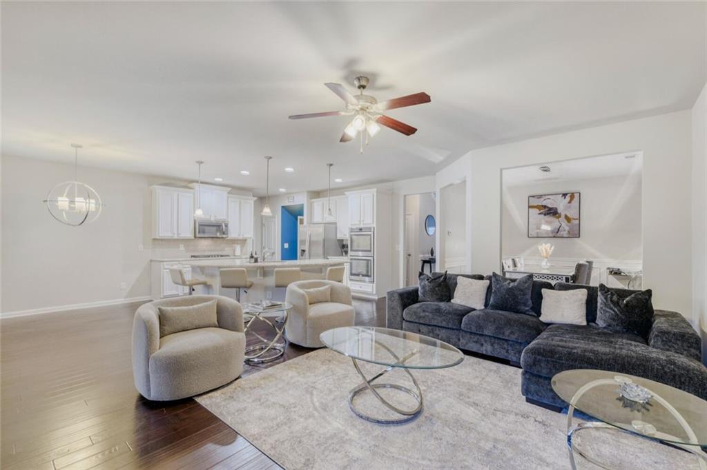 7607 Crawford Court Fairburn, GA 30213 - Photo 4 of 32 a living room with furniture and a wooden floor