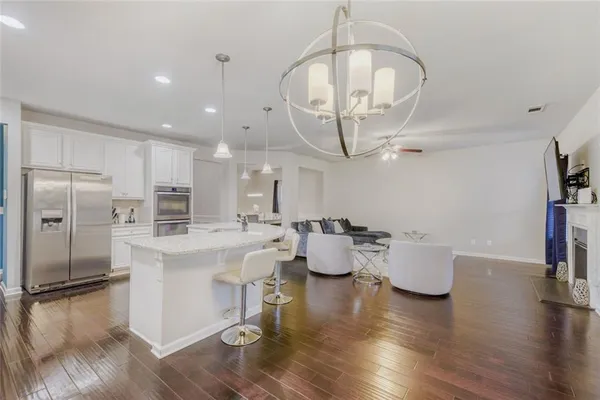 a large kitchen with a table and chairs