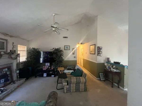 a living room with furniture a fireplace and a chandelier