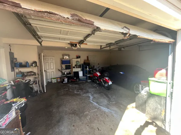 a view of a garage with a white car parked