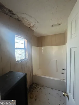 a bathroom with a bathtub and a shower