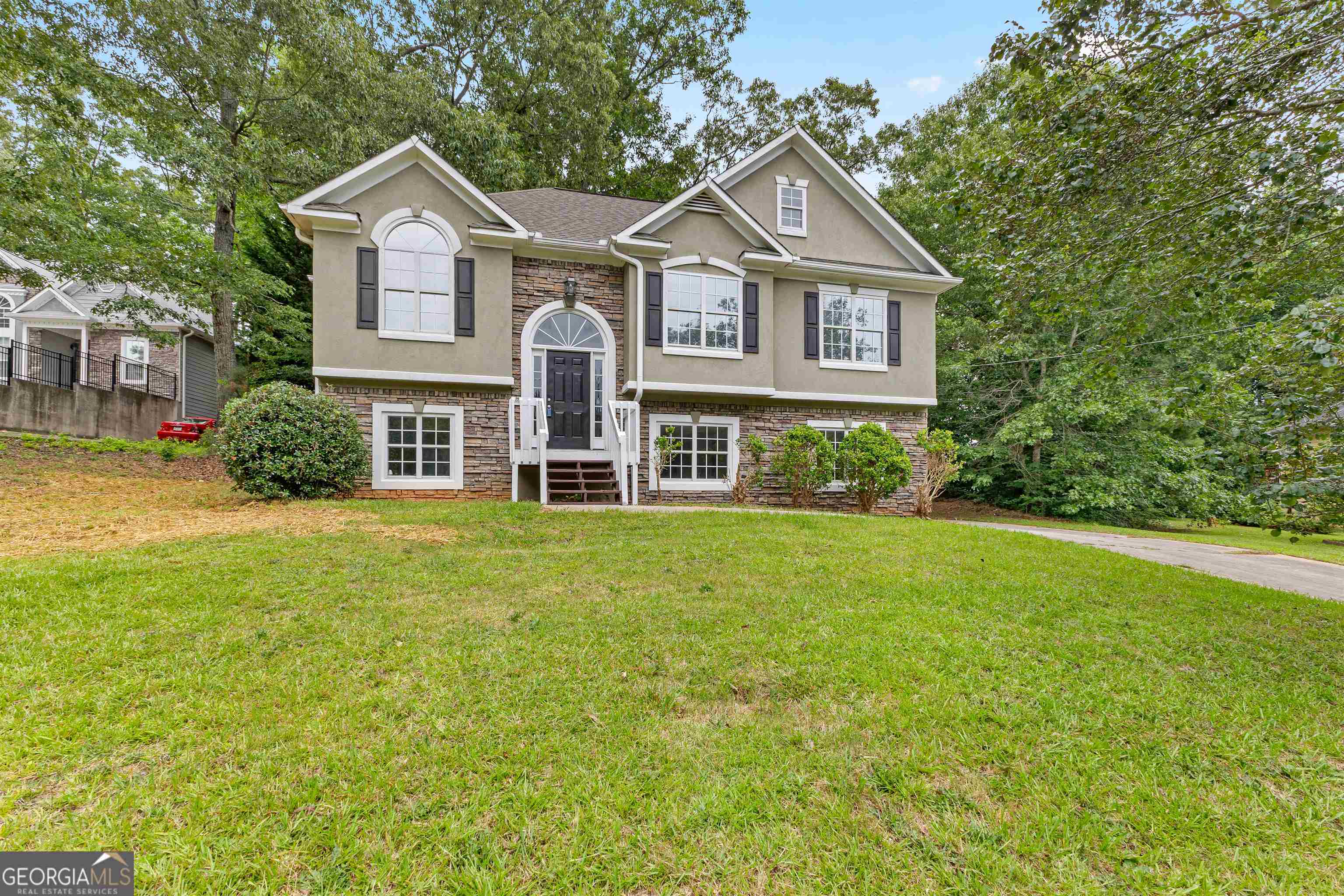 128 Hunter's Pointe Court Villa Rica, GA 30180 - Photo 1 of 1 a front of a house with a garden
