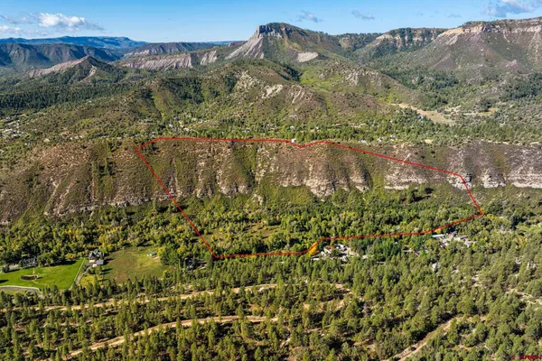 a view of a houses with a lush green hillside