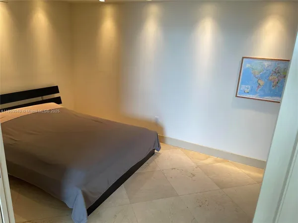 a bed sitting in a room next to a blue wall