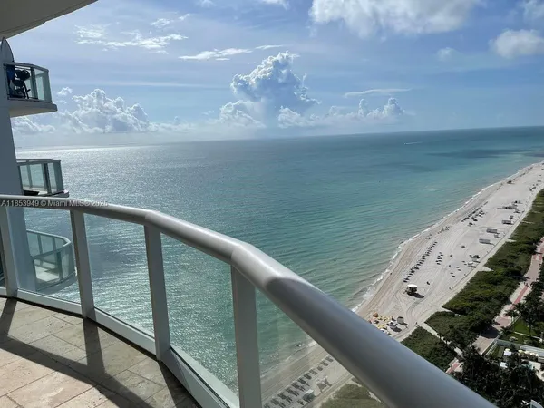 a view of a balcony next to a yard