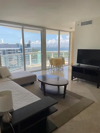 a living room with furniture and a large window