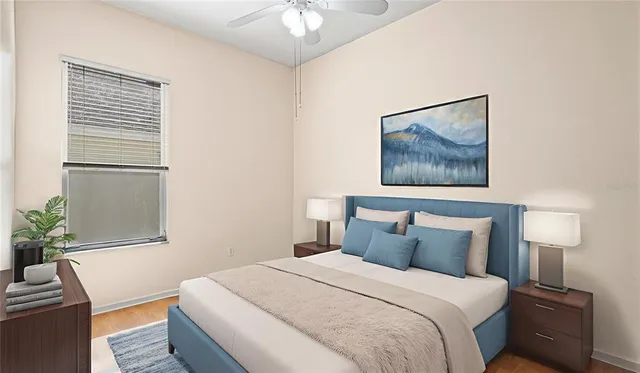 a bedroom with a bed and a painting on the wall