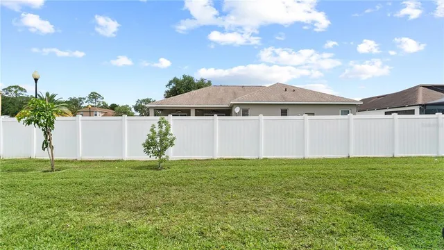 a backyard of a house with table and chairs