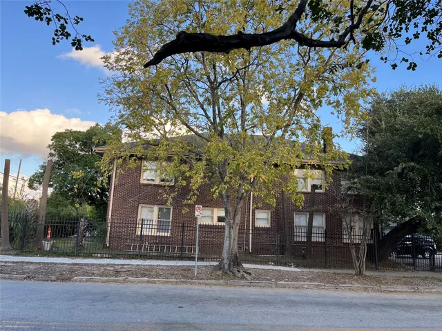 a view of a house with a tree