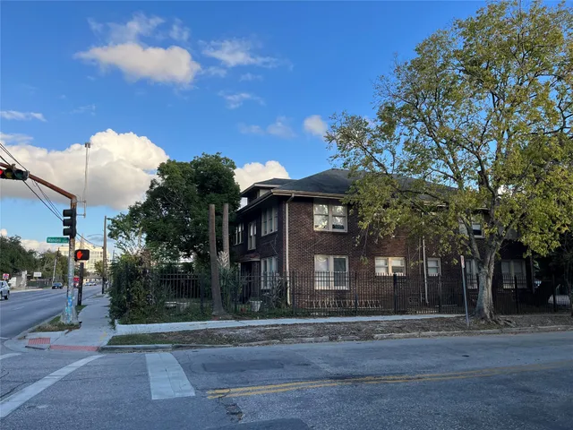 a view of a brick building next to a road