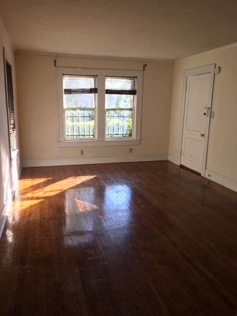 1539 Westheimer Road Houston, TX 77006 - Photo 7 of 10 an empty room with wooden floor and windows