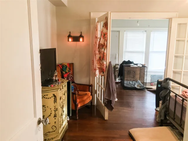 a view of living room with furniture and wooden floor