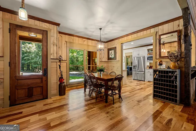 a living room with furniture a fireplace and a floor to ceiling window