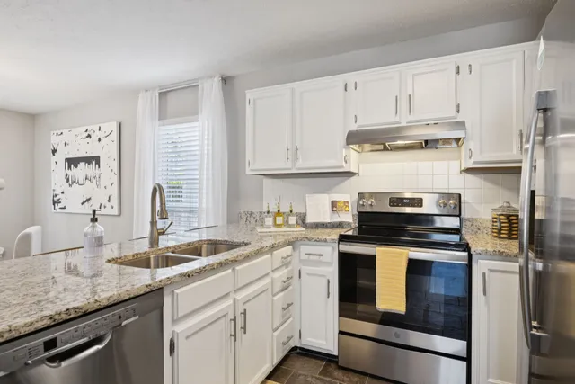 a large bed sitting in a bedroom and a chandelier