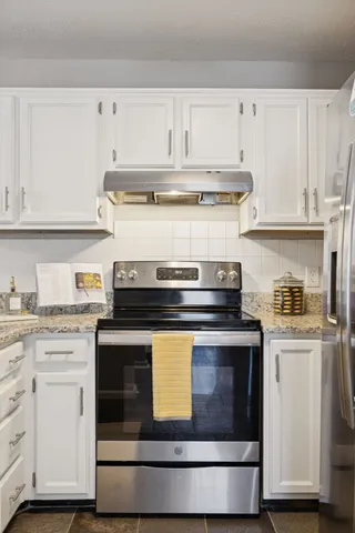 a dining room with furniture and potted plants