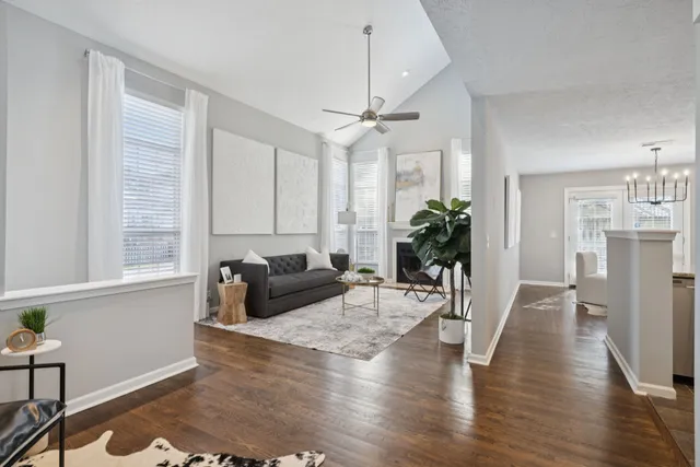 a living room with furniture and wooden floor