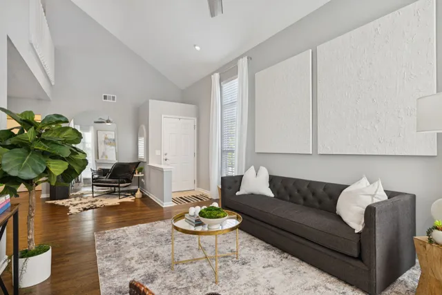 a kitchen with stainless steel appliances granite countertop a refrigerator a stove a sink and white cabinets with wooden floor