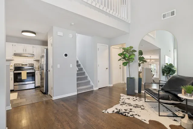 a living room with furniture and a floor to ceiling window