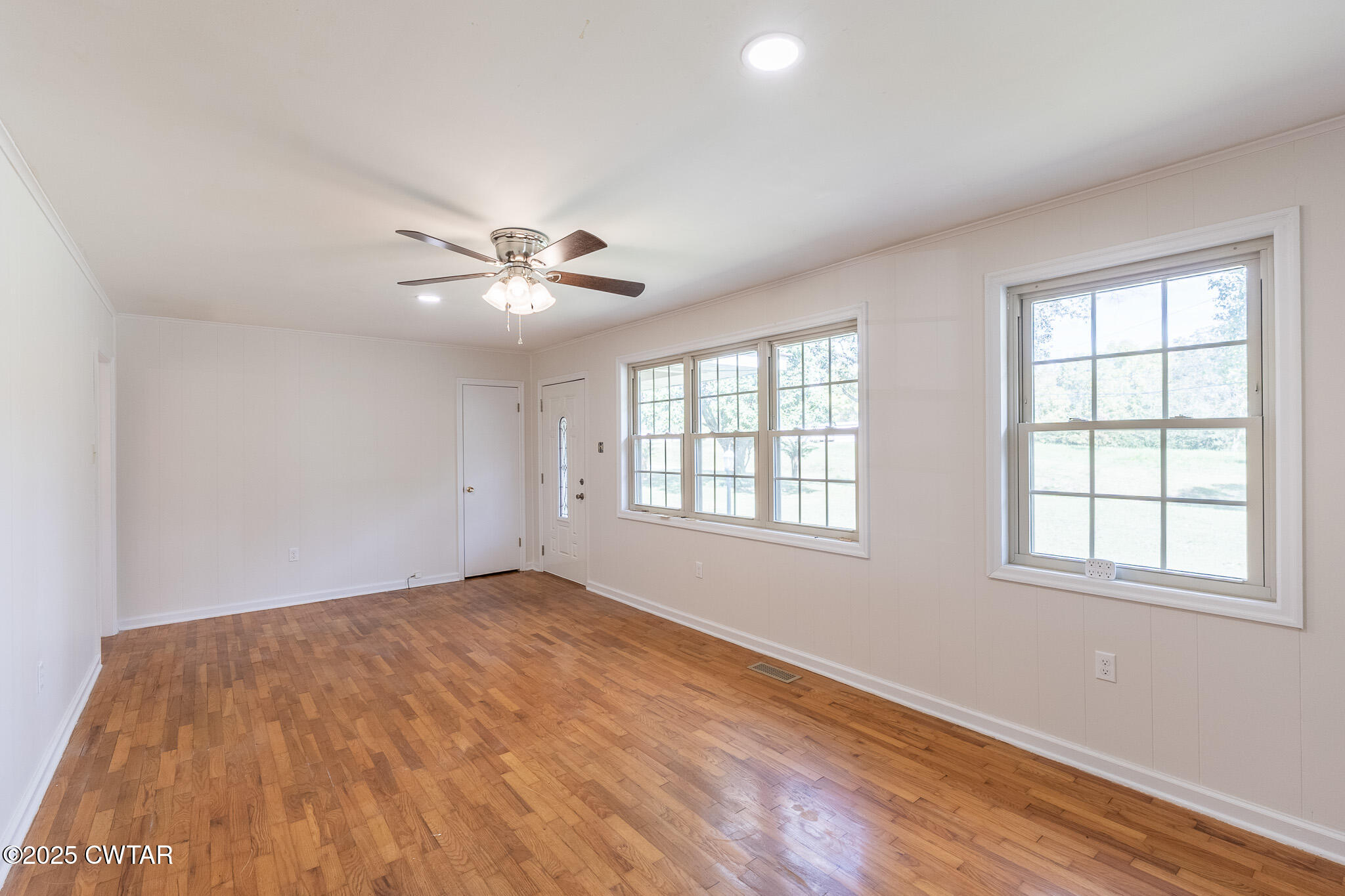 3330 Crucifer Road Huron, TN 38345 - Photo 5 of 15 an empty room with wooden floor and windows
