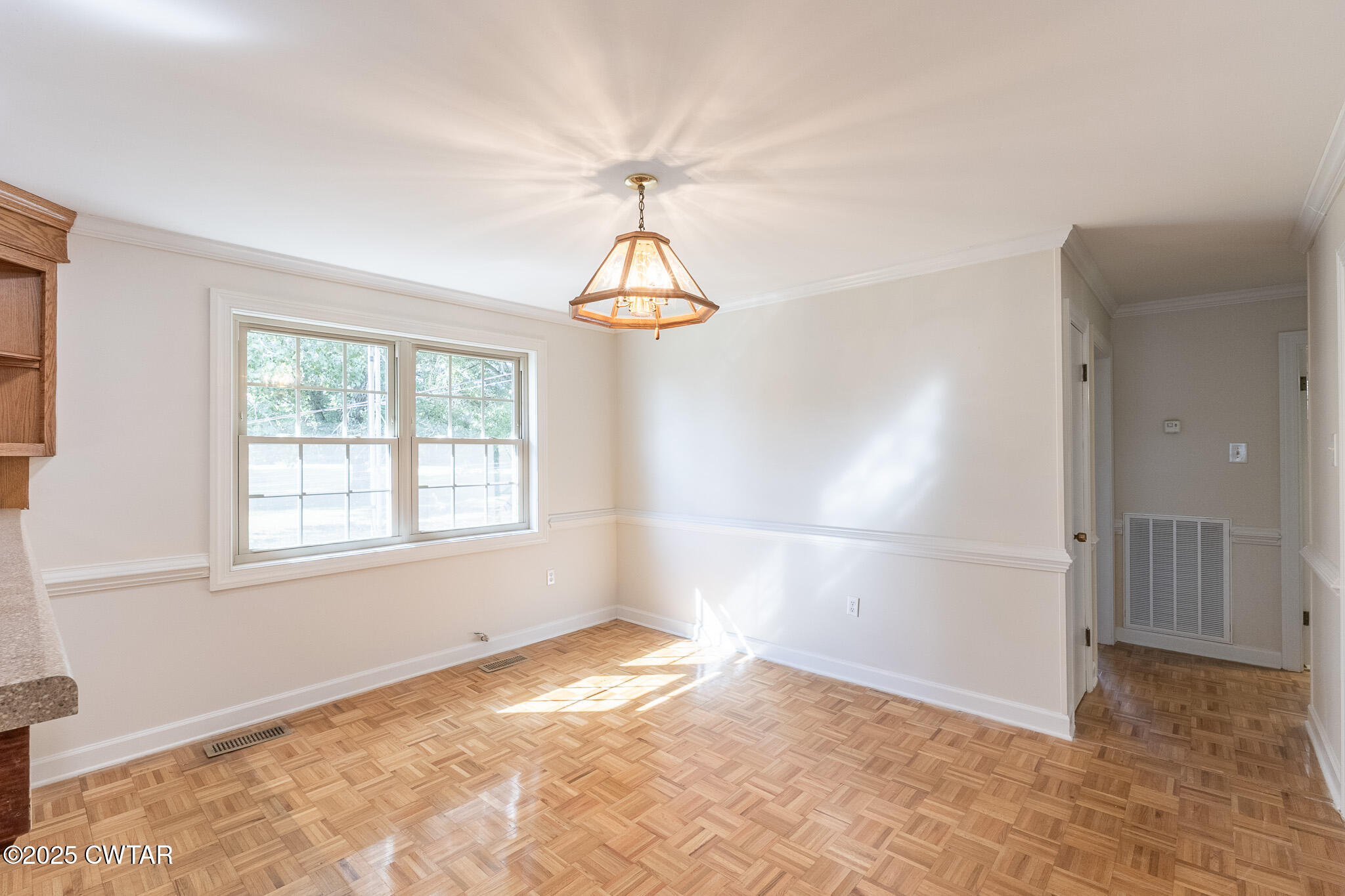 3330 Crucifer Road Huron, TN 38345 - Photo 8 of 15 an empty room with a windows and chandelier
