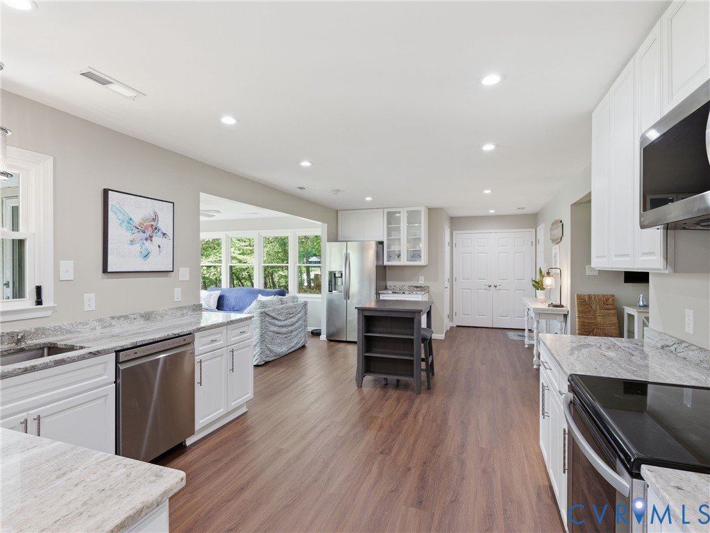 597 Harbor Drive Reedville, VA 22539 - Photo 15 of 34 Kitchen featuring wood-finish flooring, white cabi
