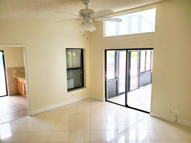 a bathroom with a granite countertop toilet sink mirror and vanity