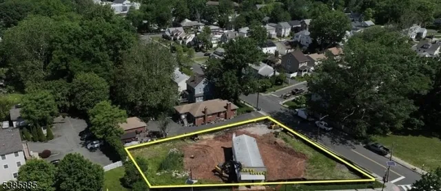an aerial view of a backyard with swimming pool and outdoor seating