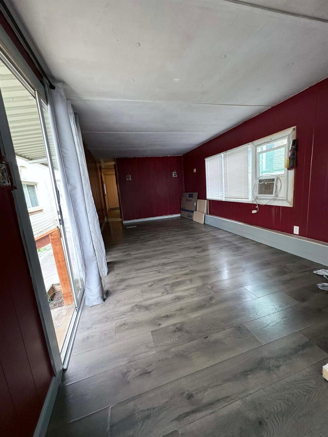 3632 9th Street Ceres, CA 95307 - Photo 11 of 23 a view of an empty room with wooden floor and a window