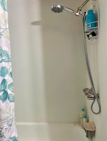 a bathroom with a shower and tub