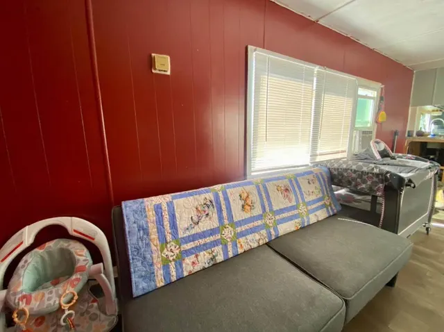 a bedroom with a bed and a window