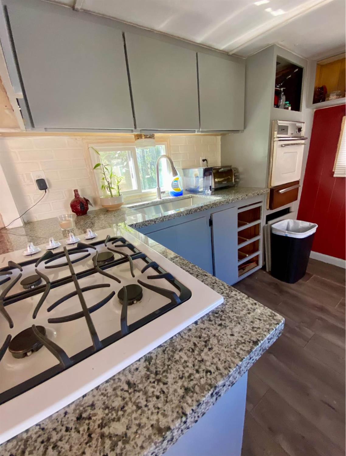 3632 9th Street Ceres, CA 95307 - Photo 5 of 23 a kitchen with stainless steel appliances granite countertop a sink stove and cabinets