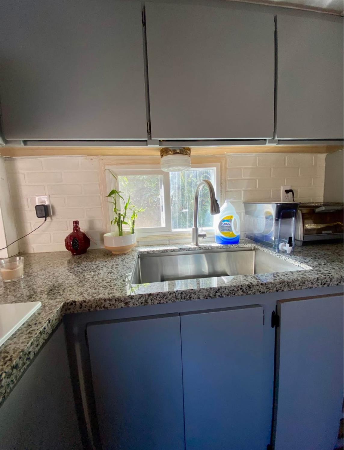 3632 9th Street Ceres, CA 95307 - Photo 6 of 23 a kitchen with granite countertop a sink and cabinets
