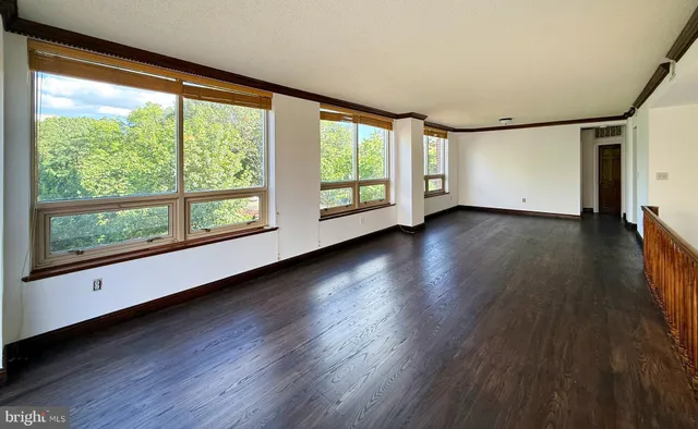 a view of a room with wooden floor