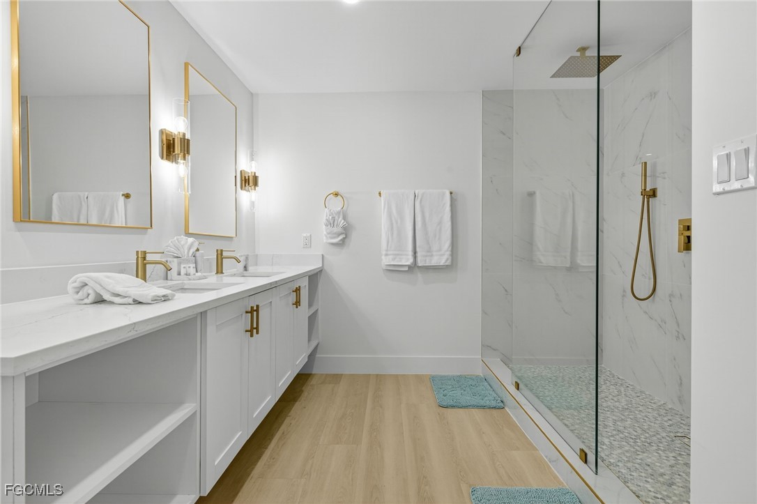 1377 Sand Castle Road Sanibel, FL 33957 - Photo 20 of 49 a bathroom with a double vanity sink mirror and shower