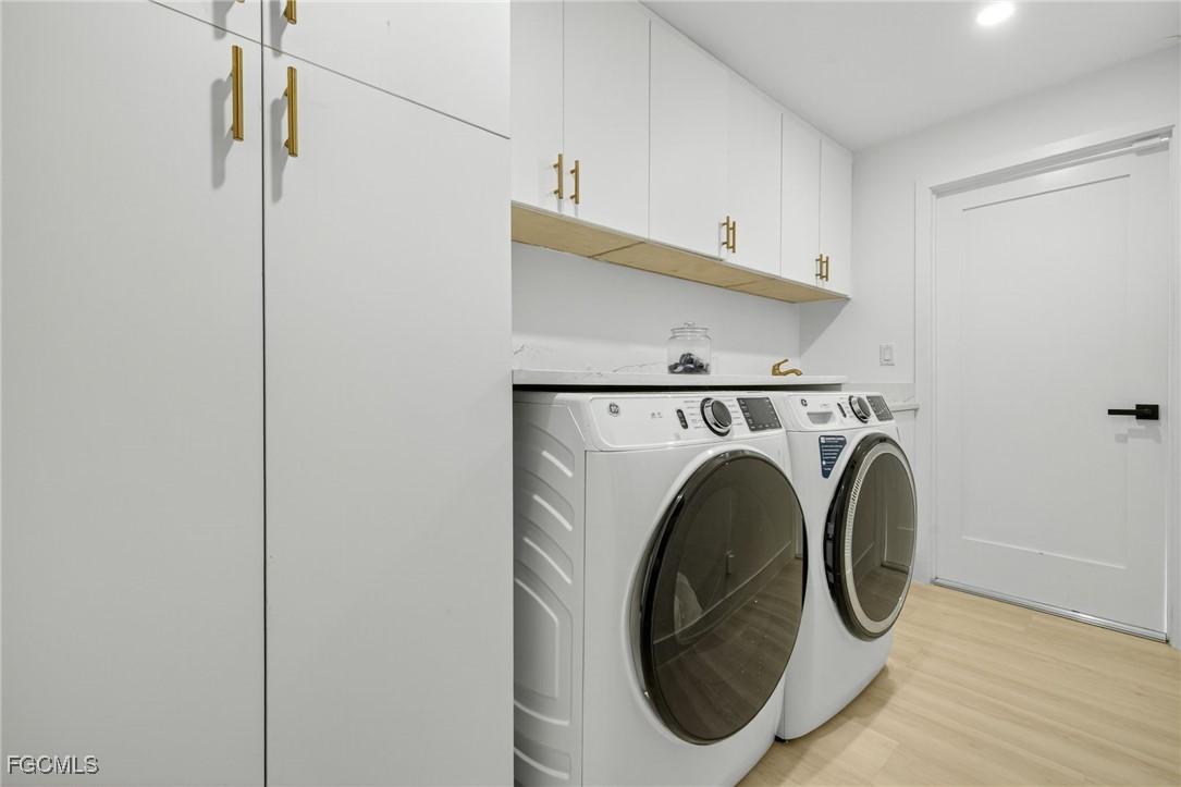 1377 Sand Castle Road Sanibel, FL 33957 - Photo 32 of 49 a utility room with dryer and washer