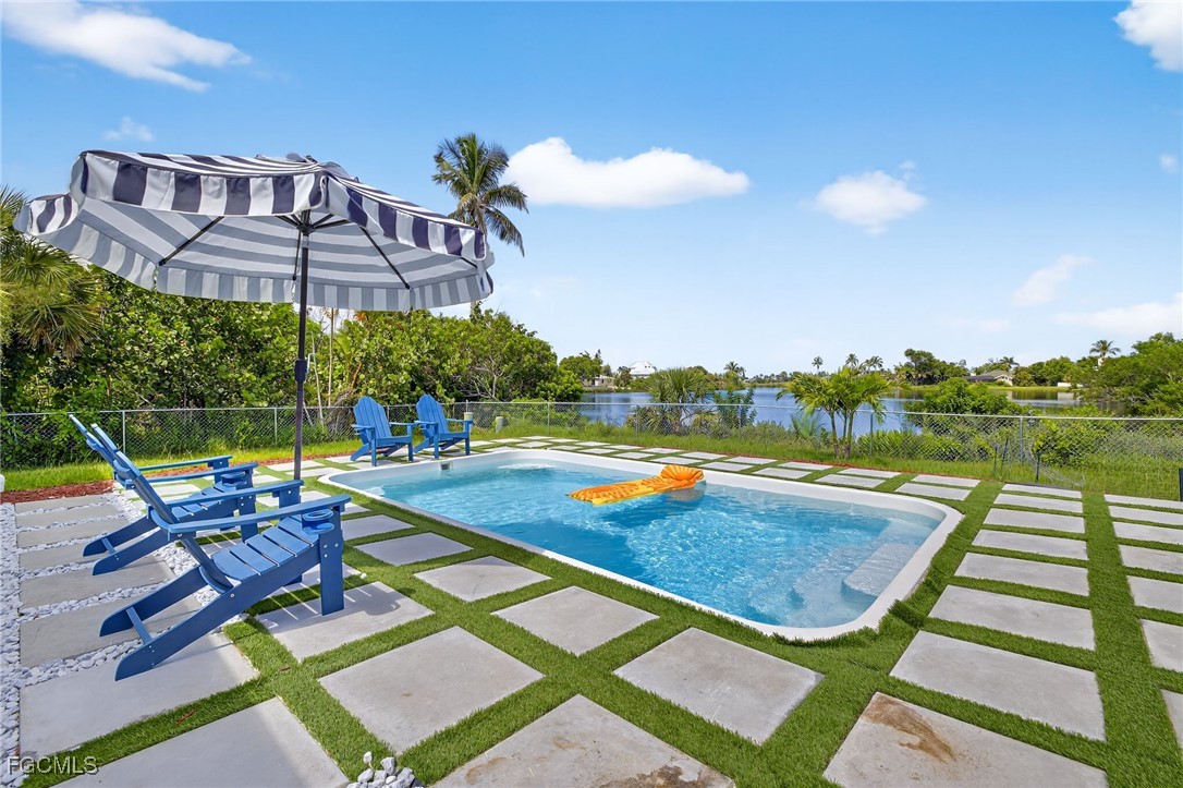 1377 Sand Castle Road Sanibel, FL 33957 - Photo 34 of 49 a view of a swimming pool with lounge chairs
