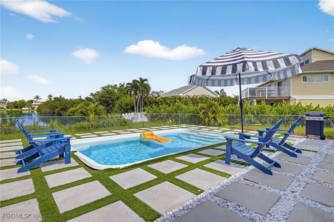 1377 Sand Castle Road Sanibel, FL 33957 - Photo 37 of 49 a view of a swimming pool with a lounge chairs