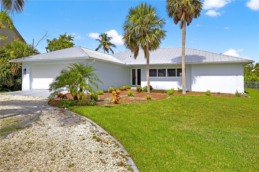 1377 Sand Castle Road Sanibel, FL 33957 - Photo 46 of 49 a front view of a house with garden
