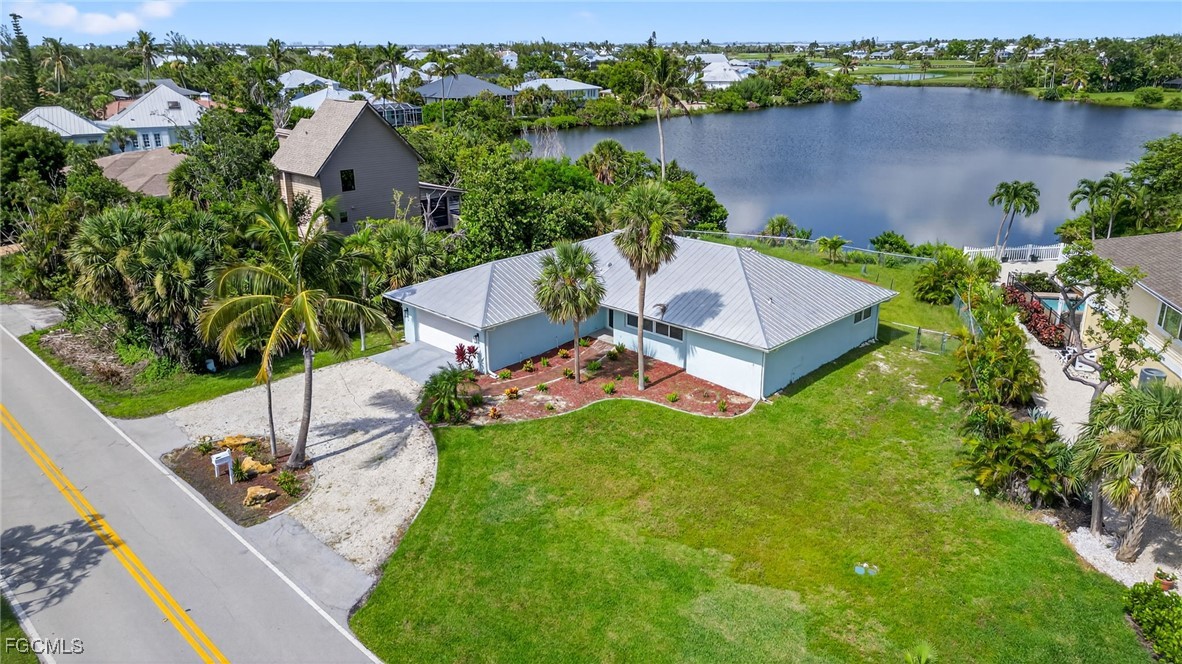 1377 Sand Castle Road Sanibel, FL 33957 - Photo 5 of 49 an aerial view of a house with garden space and lake view