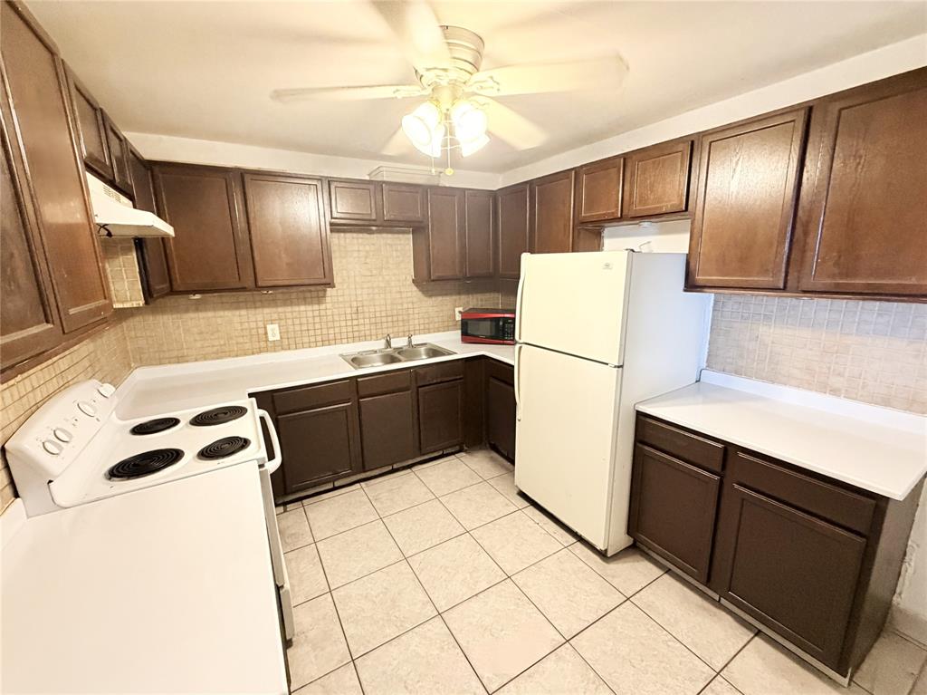 1829 North A Street, Unit 13 Lake Worth Beach, FL 33460 - Photo 1 of 14 a kitchen with stainless steel appliances a refrigerator sink and stove