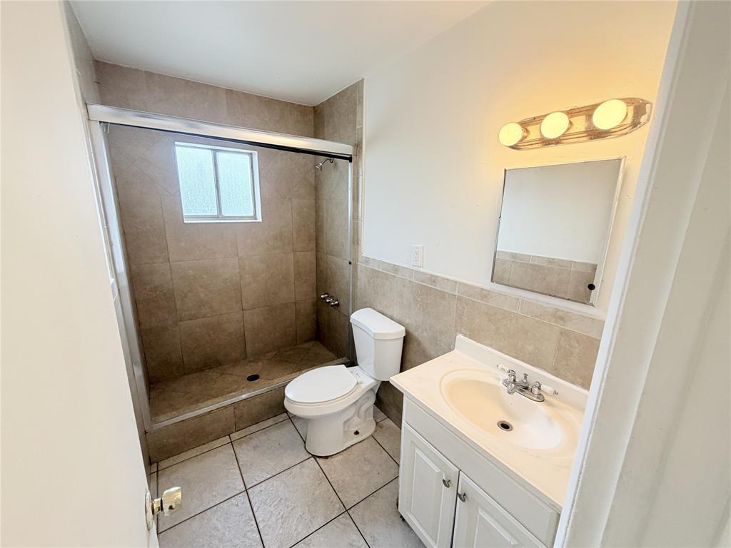 1829 North A Street, Unit 13 Lake Worth Beach, FL 33460 - Photo 11 of 14 a bathroom with a sink toilet a mirror and shower