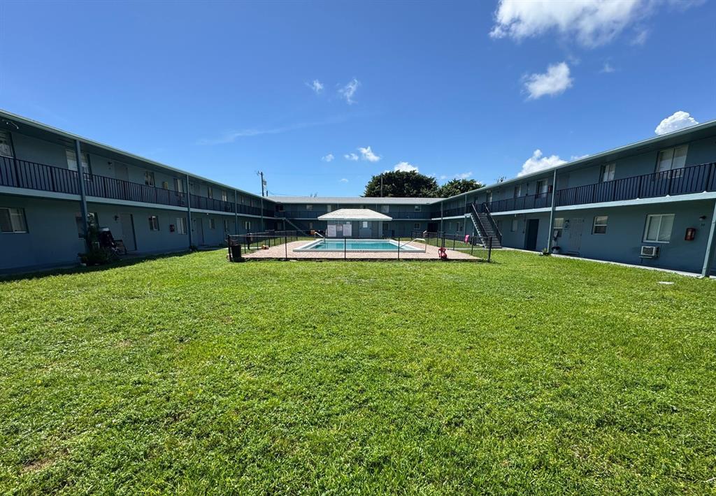 1829 North A Street, Unit 13 Lake Worth Beach, FL 33460 - Photo 13 of 14 a view of a house with a yard